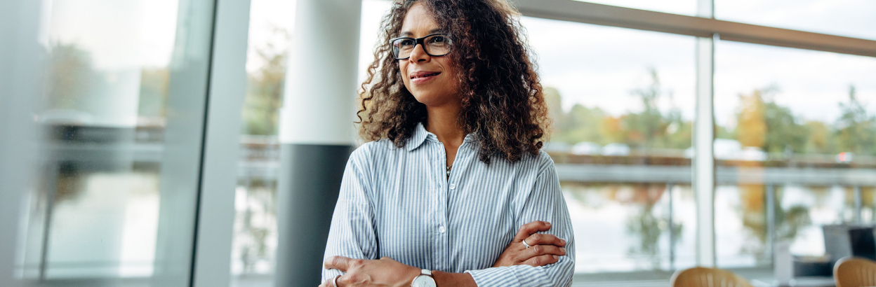 Female entrepreneur standing at office window