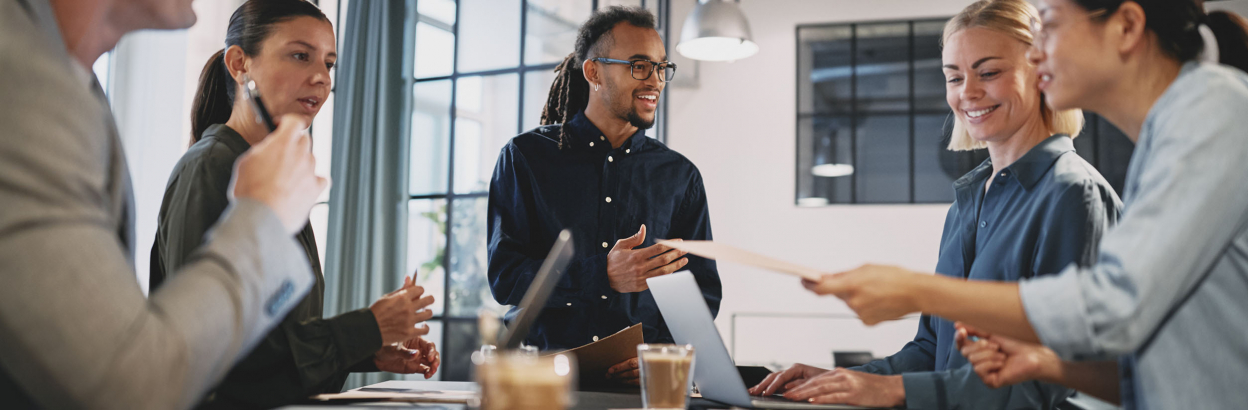 Young businessman talking with staff during an office meeting