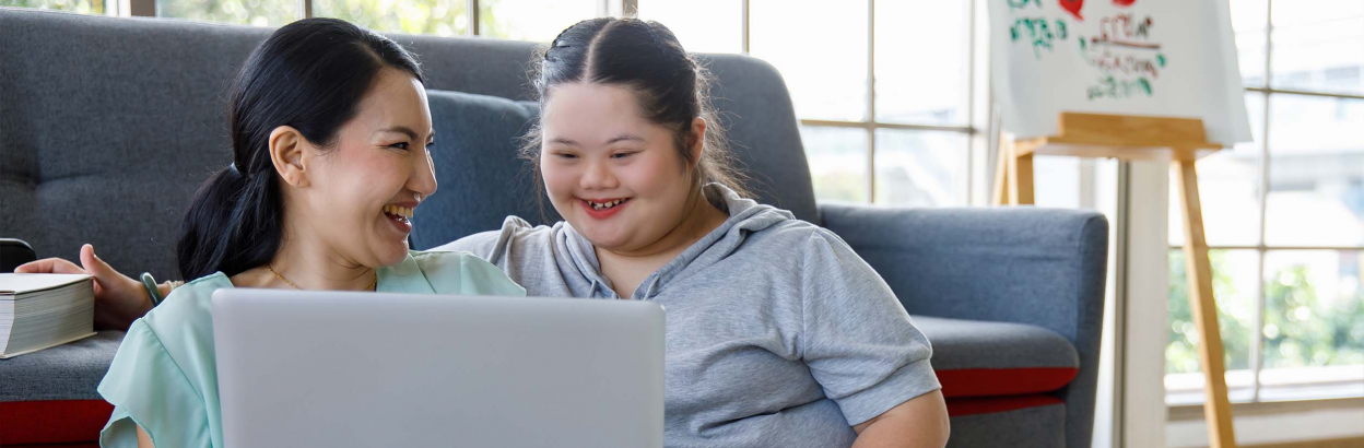 mother and daughter embracing on couch