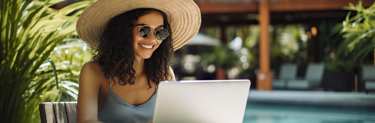 woman at tropical resort on laptop