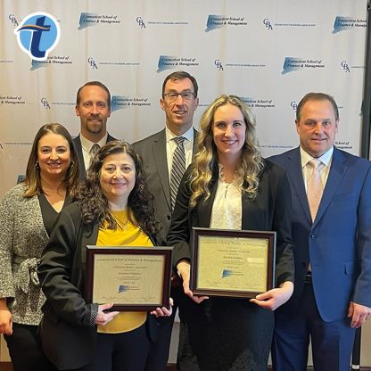 Rosanne Palladino and Rachael Gagnon, holding their respective Connecticut School of Finance and Management diplomas, pose for a photo with Thomaston Savings Bank executives.